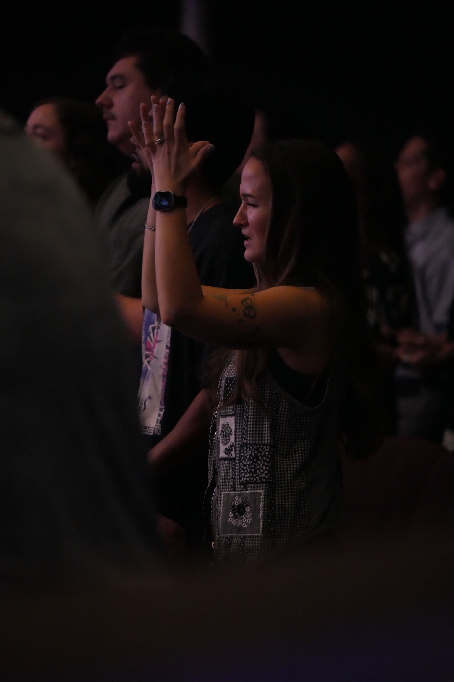 People praying during worship at Elevated Church in Pinellas Park, Florida